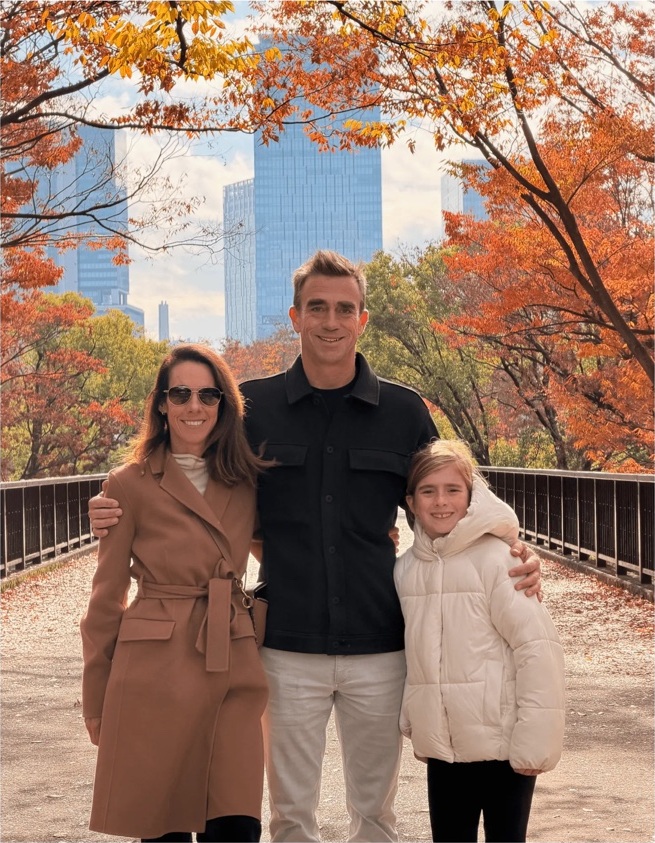 Andrew, Sara, and Elliot together in Japan beneath autumn trees
