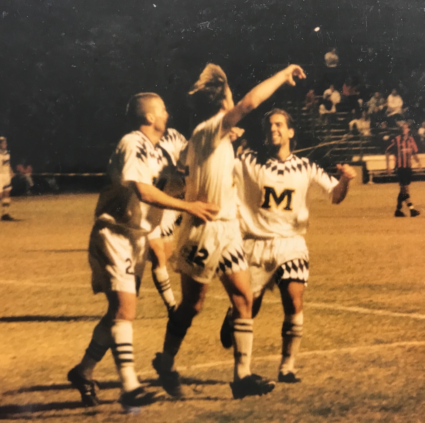 University of Michigan soccer players celebrating after the game-winning goal in a national final